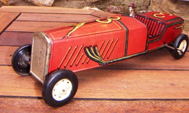Featured is a winning number in the world of electric, battery, and wind-up antique toys ... a tin litho wind-up jalopy.